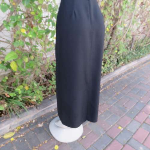 Ankle length black crepe polyester pencil skirt with pleat and zip at back. Size 40/16 by DIANELLO.