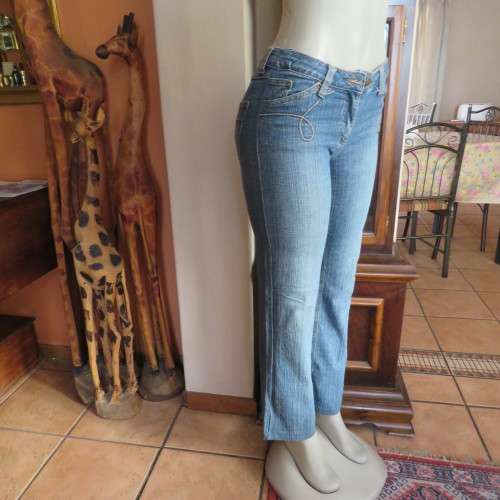 Straight legged blue ankle length jeans by WWW size 34/10. Very little stretch. Pockets back/front..