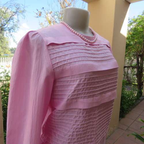 Romantic rose pink top. Long puffed sleeves and button down back.Decorative front tucking.Size 35/11