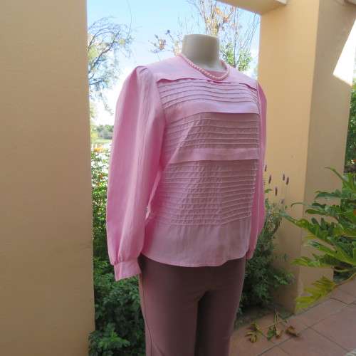 Romantic rose pink top. Long puffed sleeves and button down back.Decorative front tucking.Size 35/11
