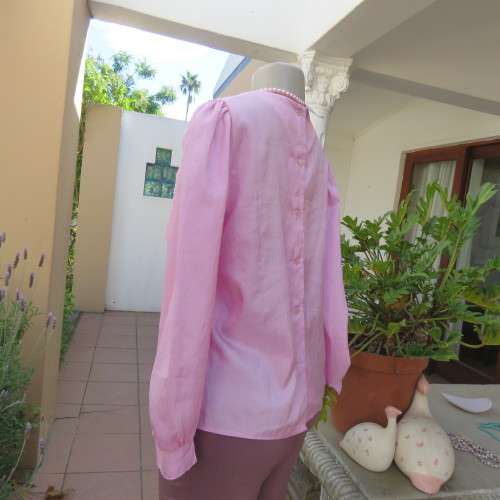 Romantic rose pink top. Long puffed sleeves and button down back.Decorative front tucking.Size 35/11