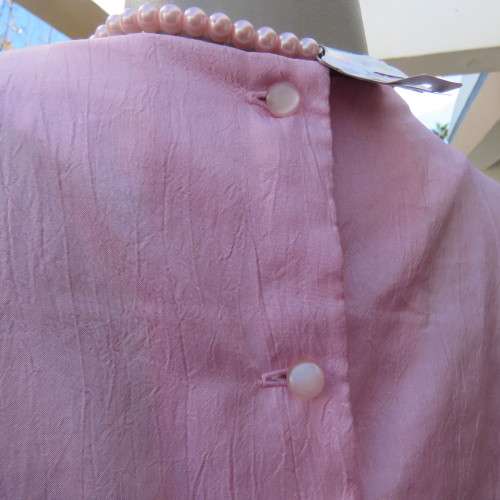 Romantic rose pink top. Long puffed sleeves and button down back.Decorative front tucking.Size 35/11