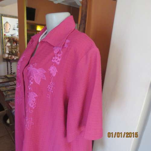 Top of the line magenta pink richly embroidered short sleeve bubble polyester top. Size 46. As new