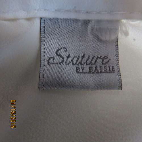 Cool sleeveless summer top in cream polyester. Pretty embroidery on collar and front.Size 36. As new