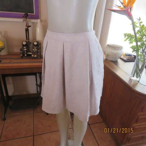 Charming light grey floral embossed poly/nylon knee length skirt.Size 36. Inverted front pleats.
