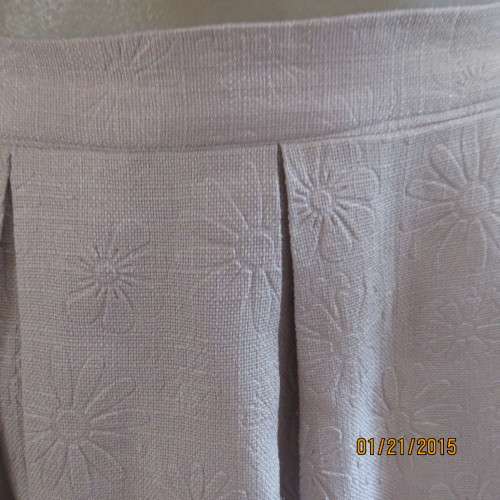 Charming light grey floral embossed poly/nylon knee length skirt.Size 36. Inverted front pleats.