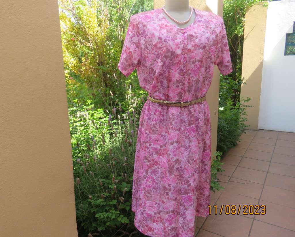 Beautiful textured silky poly dress with roses in pink shades. Size 40. Elasticated waist. As new.