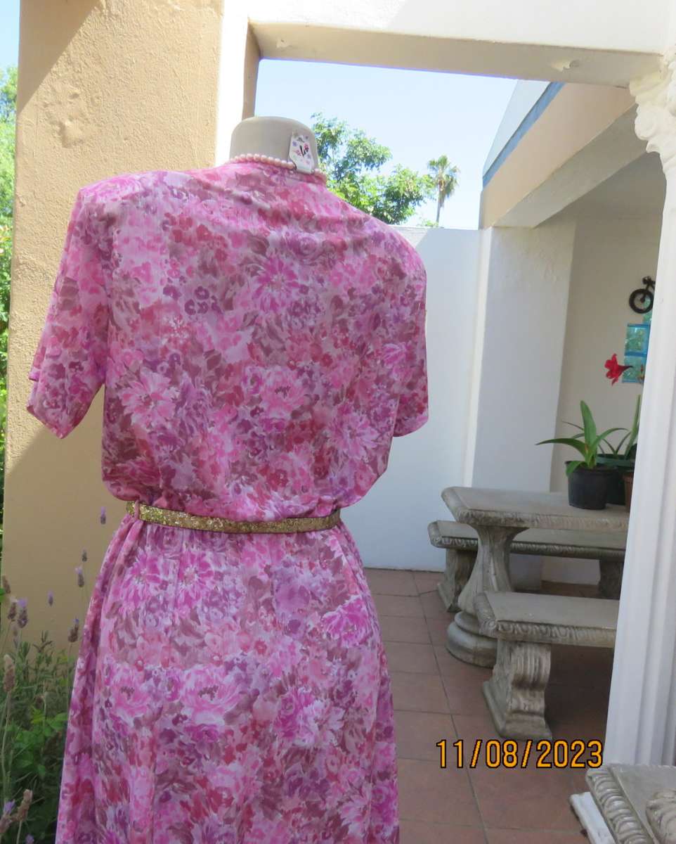 Beautiful textured silky poly dress with roses in pink shades. Size 40. Elasticated waist. As new.