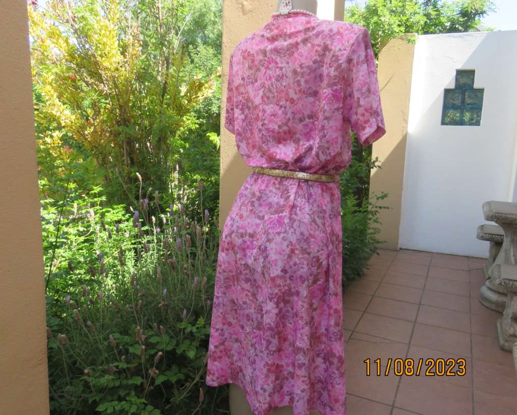 Beautiful textured silky poly dress with roses in pink shades. Size 40. Elasticated waist. As new.