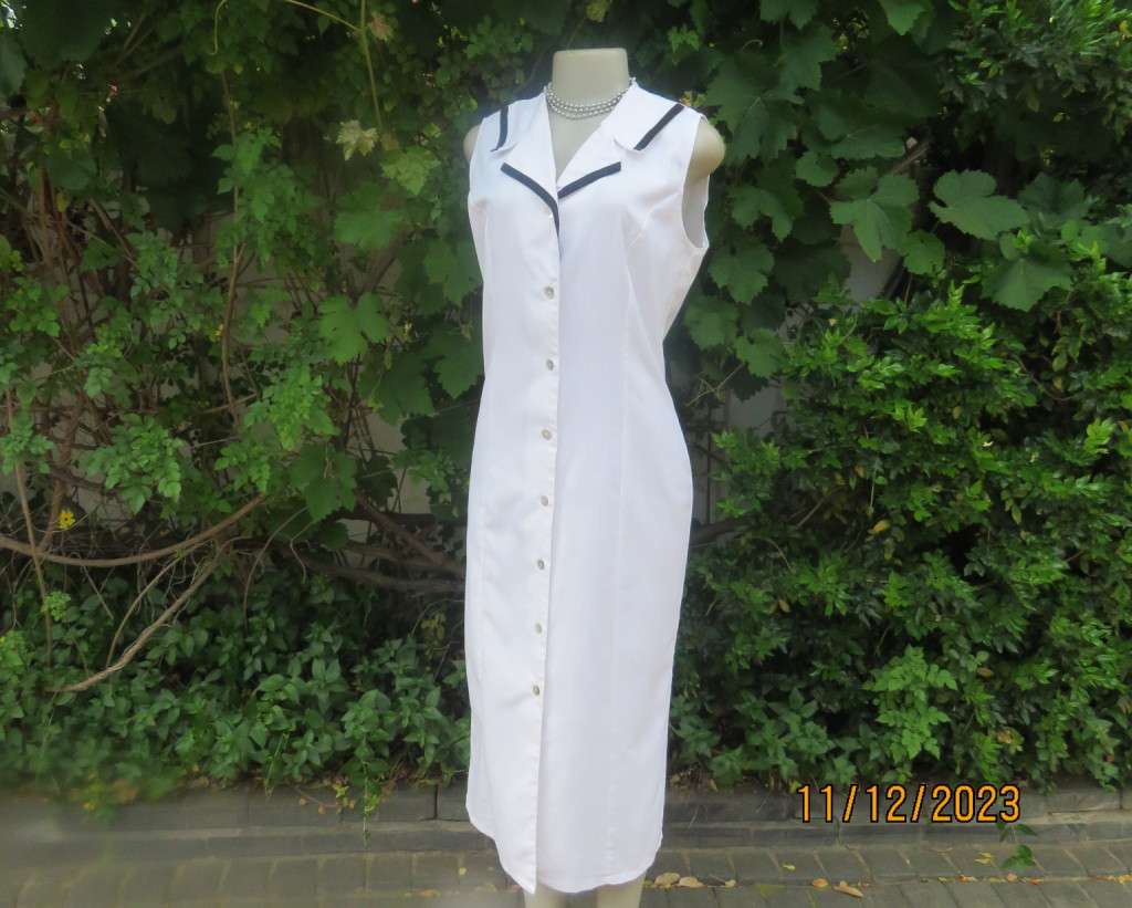 Winner for Summer! Sleek button down white ankle length dress. Size 36. Open collar/black edging.