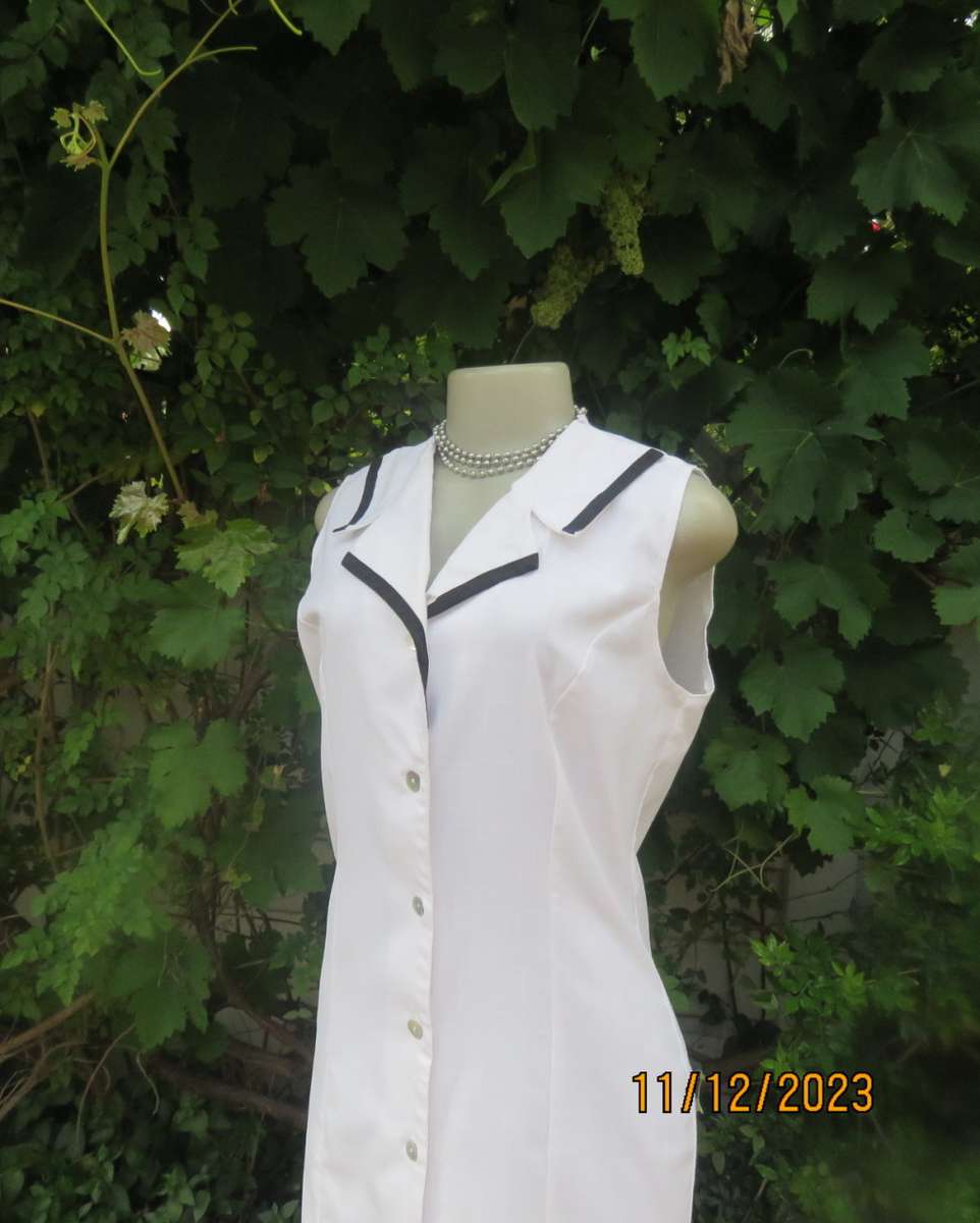 Winner for Summer! Sleek button down white ankle length dress. Size 36. Open collar/black edging.