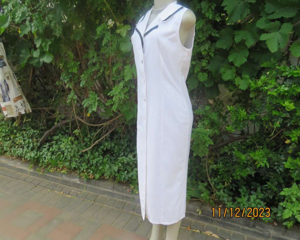 Winner for Summer! Sleek button down white ankle length dress. Size 36. Open collar/black edging.