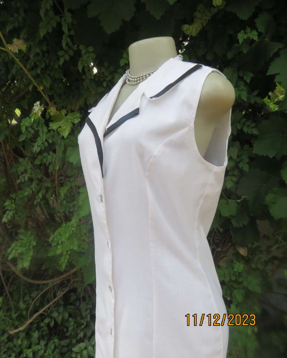 Winner for Summer! Sleek button down white ankle length dress. Size 36. Open collar/black edging.