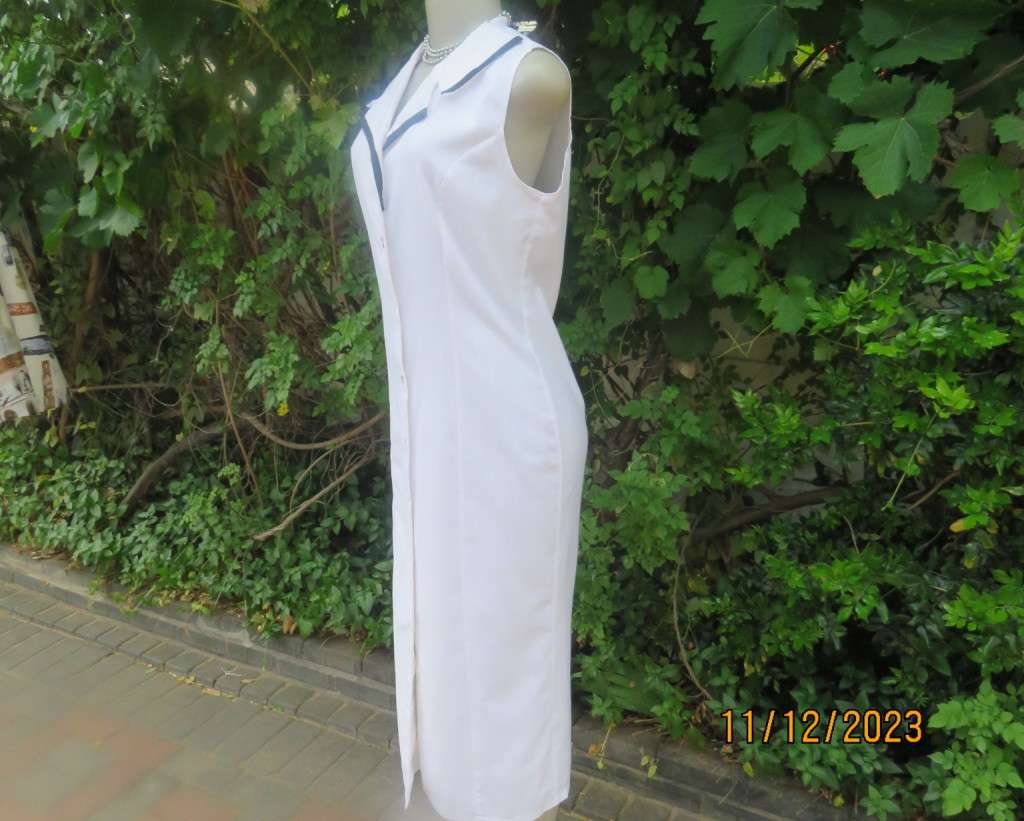 Winner for Summer! Sleek button down white ankle length dress. Size 36. Open collar/black edging.