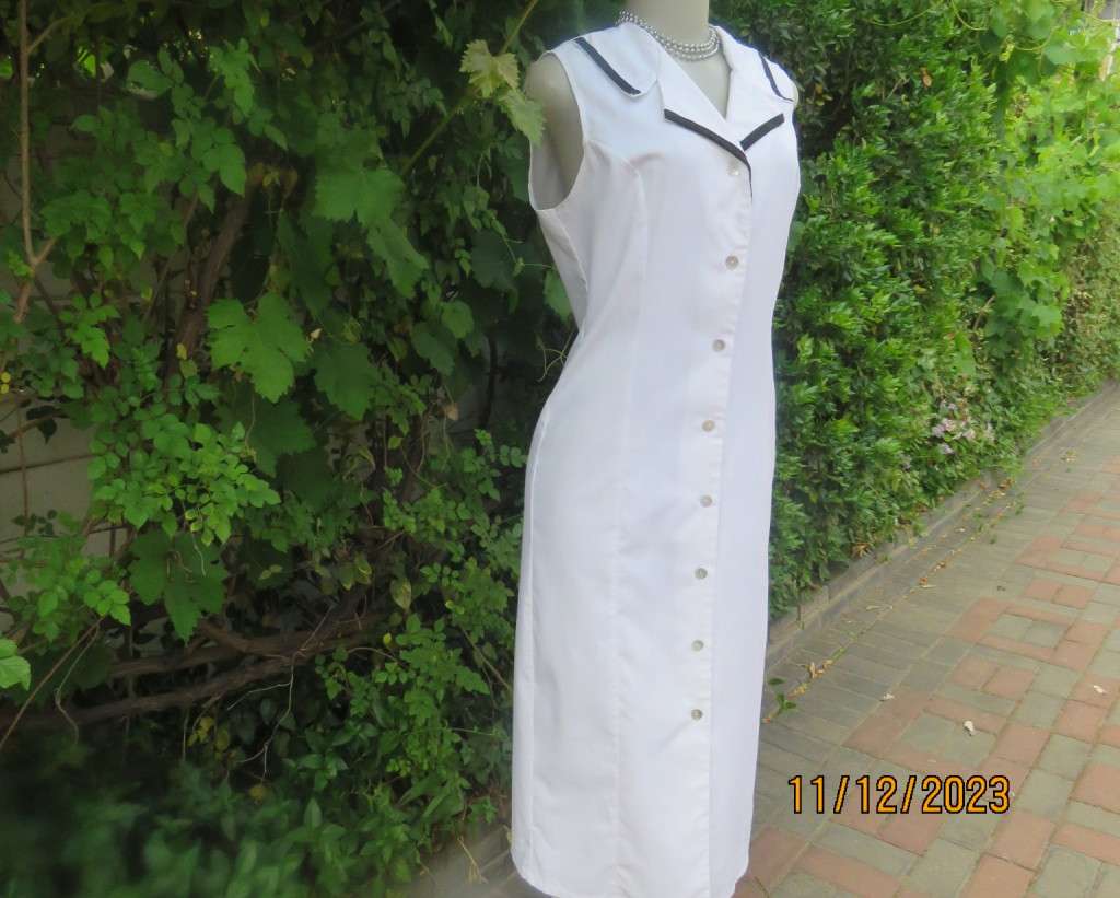 Winner for Summer! Sleek button down white ankle length dress. Size 36. Open collar/black edging.