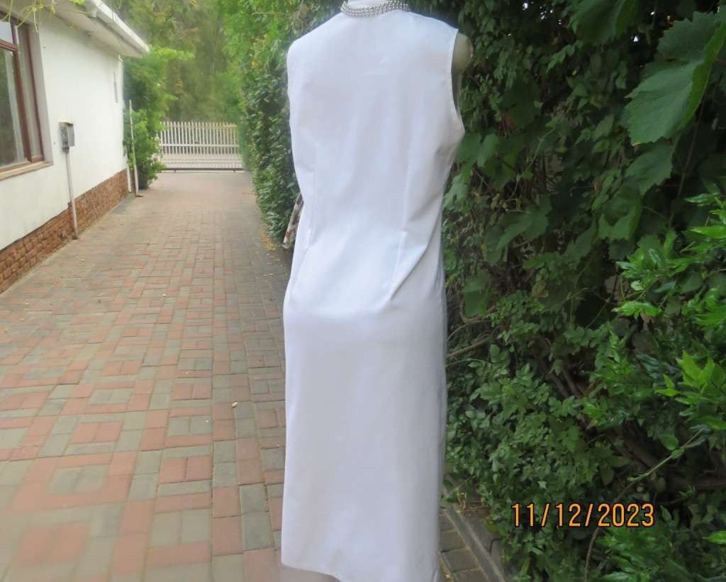 Winner for Summer! Sleek button down white ankle length dress. Size 36. Open collar/black edging.