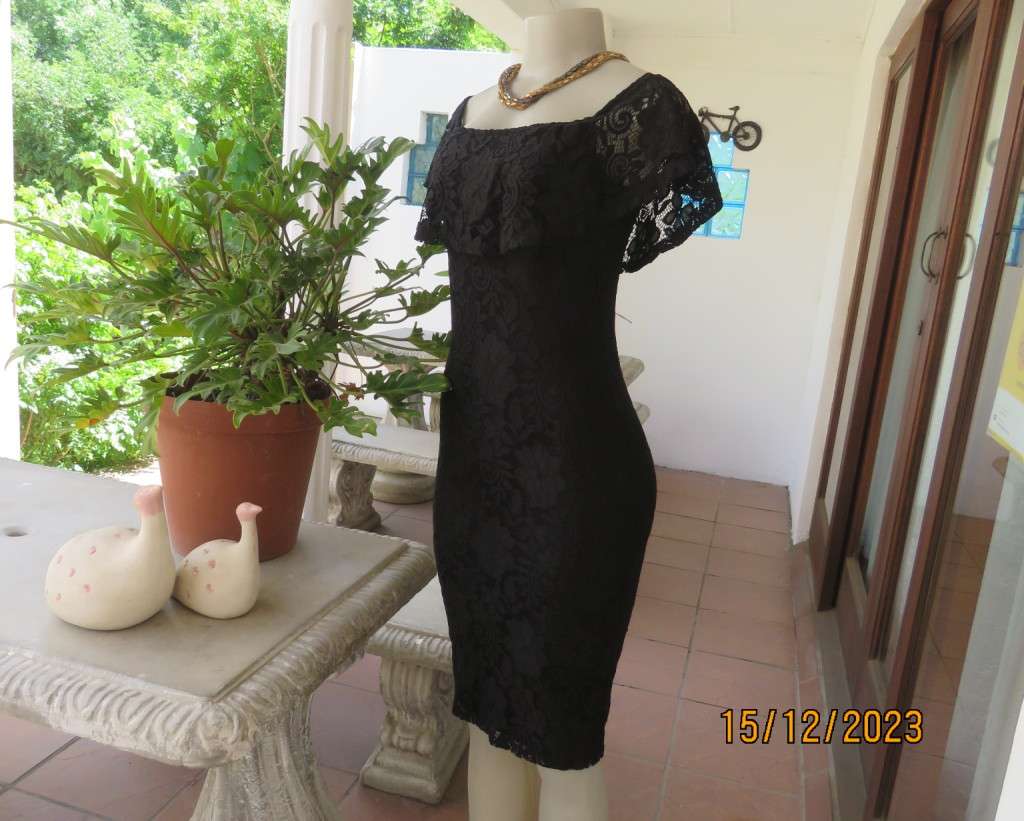 The little black poly/nylon lace dress. Lining stretch poly. Off shoulder/frilled neckline.Size 32