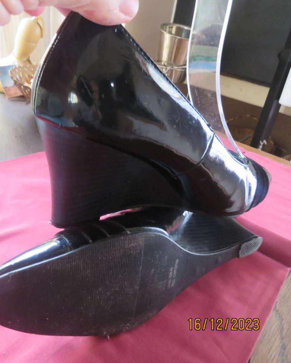 Pair of black shiny patent leather wedge heel shoes by QUEENSPARK size 5. Velvet crossovers.As new