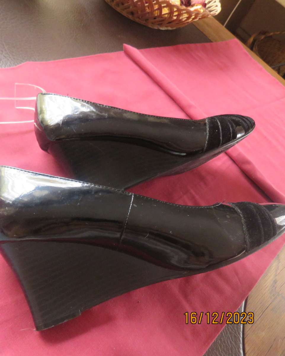 Pair of black shiny patent leather wedge heel shoes by QUEENSPARK size 5. Velvet crossovers.As new