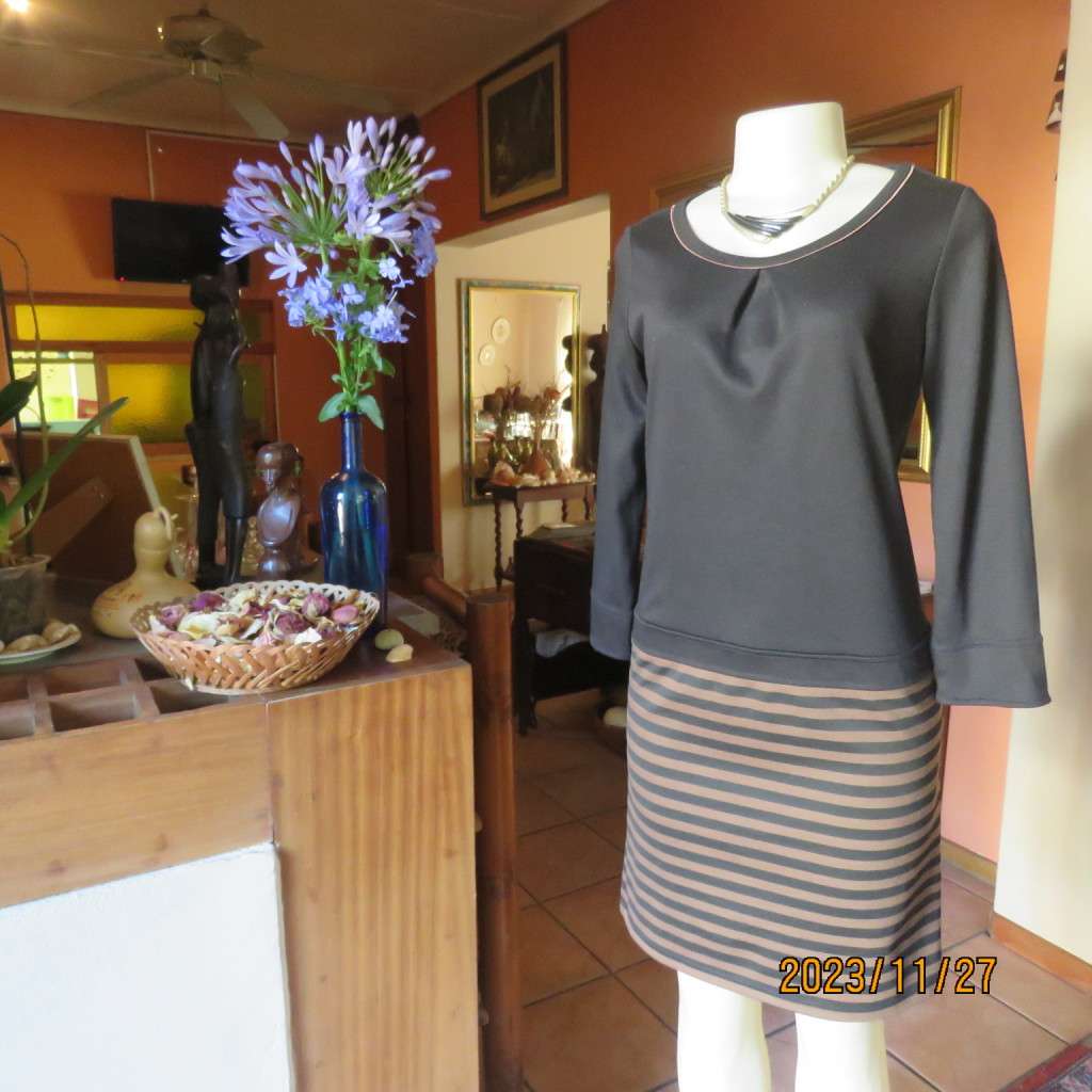 Elegant black jersey shift dress with black/brown striped bottom. Long sleeves. Size 34 from Korea.