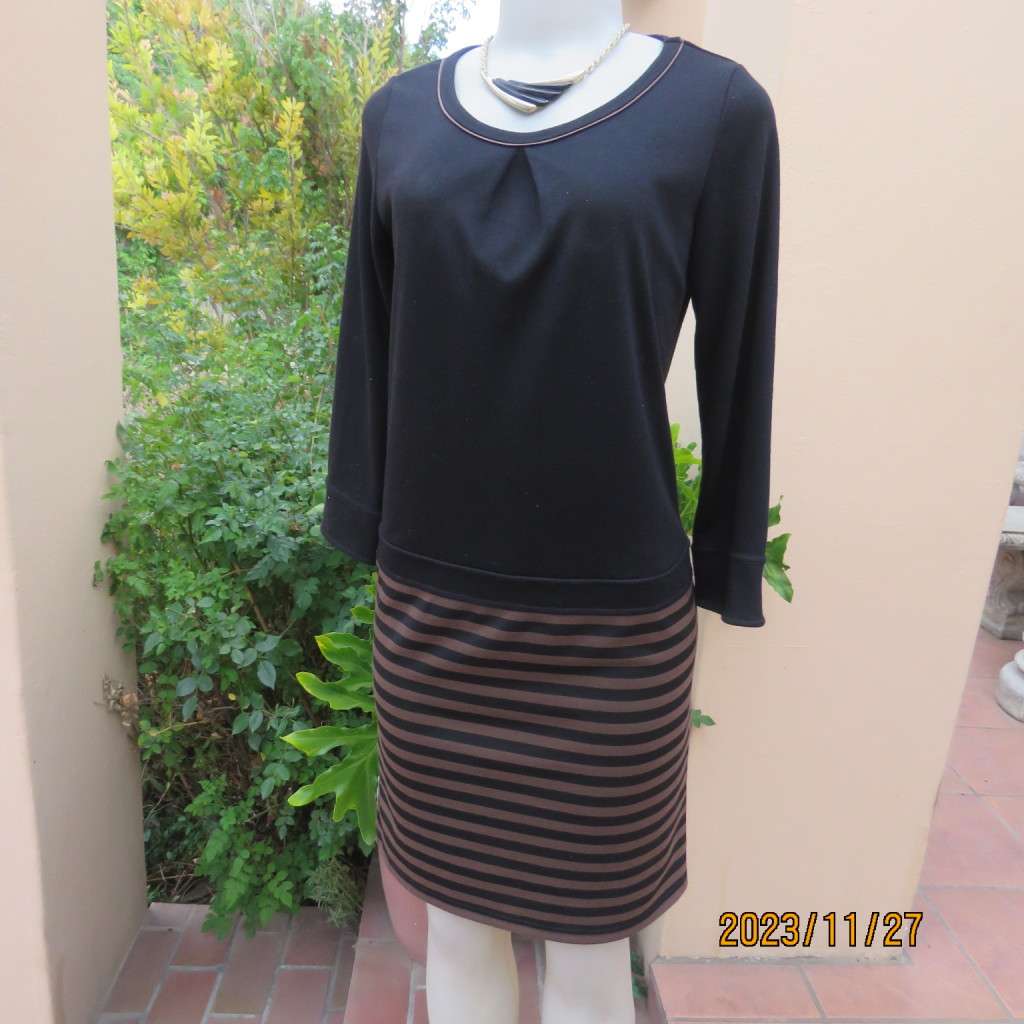 Elegant black jersey shift dress with black/brown striped bottom. Long sleeves. Size 34 from Korea.
