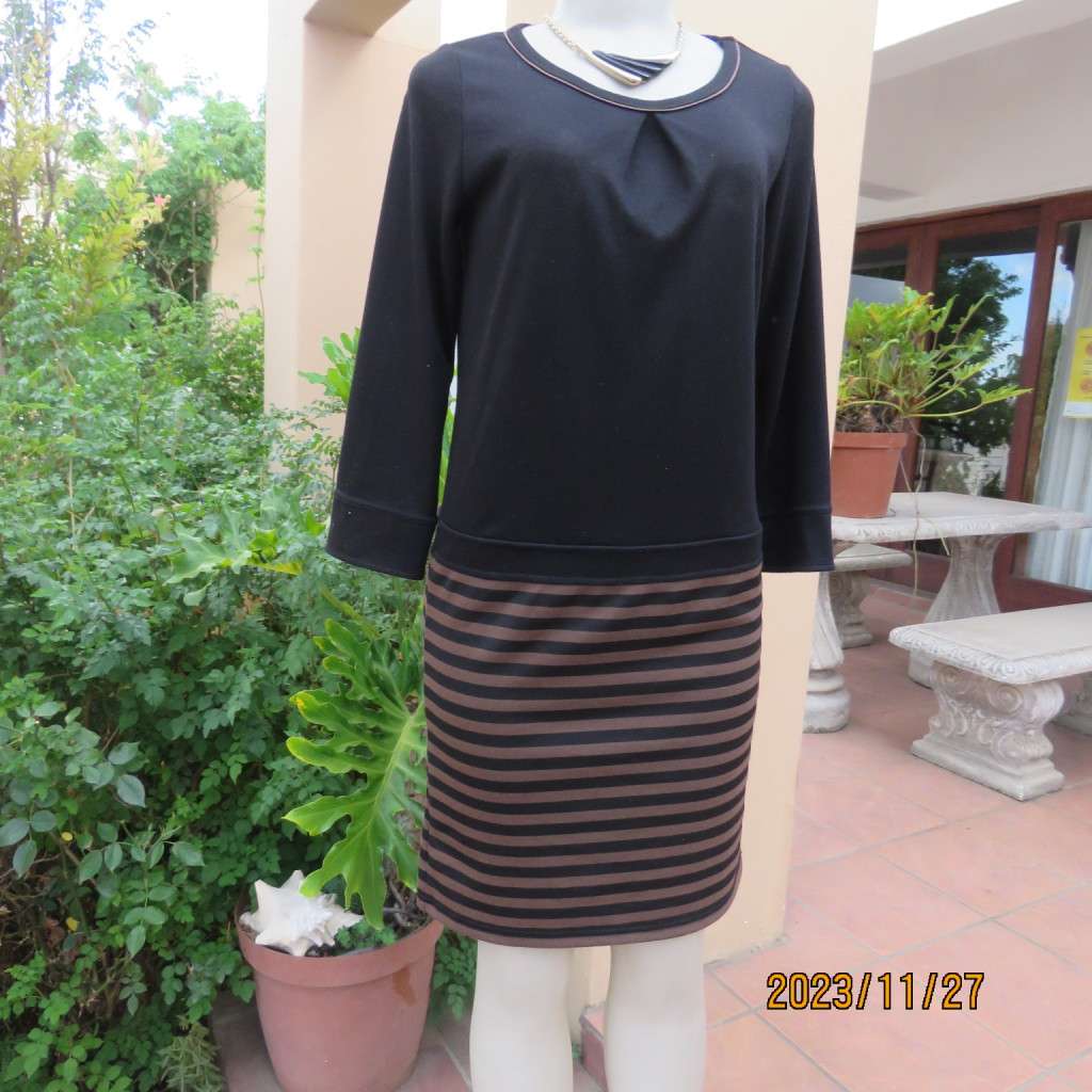 Elegant black jersey shift dress with black/brown striped bottom. Long sleeves. Size 34 from Korea.