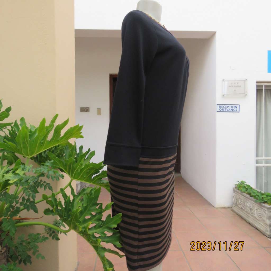 Elegant black jersey shift dress with black/brown striped bottom. Long sleeves. Size 34 from Korea.