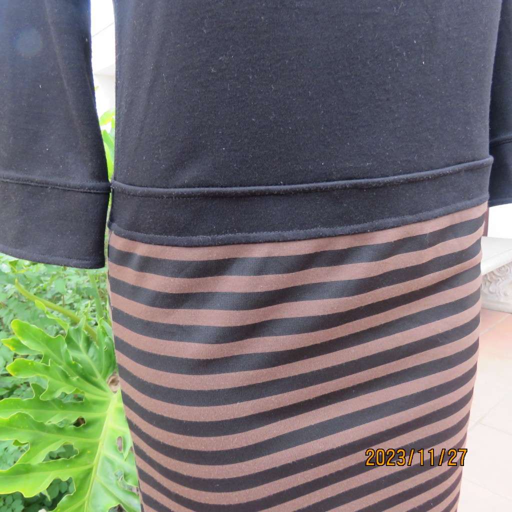 Elegant black jersey shift dress with black/brown striped bottom. Long sleeves. Size 34 from Korea.