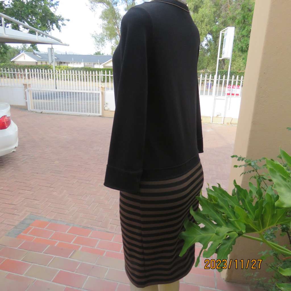 Elegant black jersey shift dress with black/brown striped bottom. Long sleeves. Size 34 from Korea.