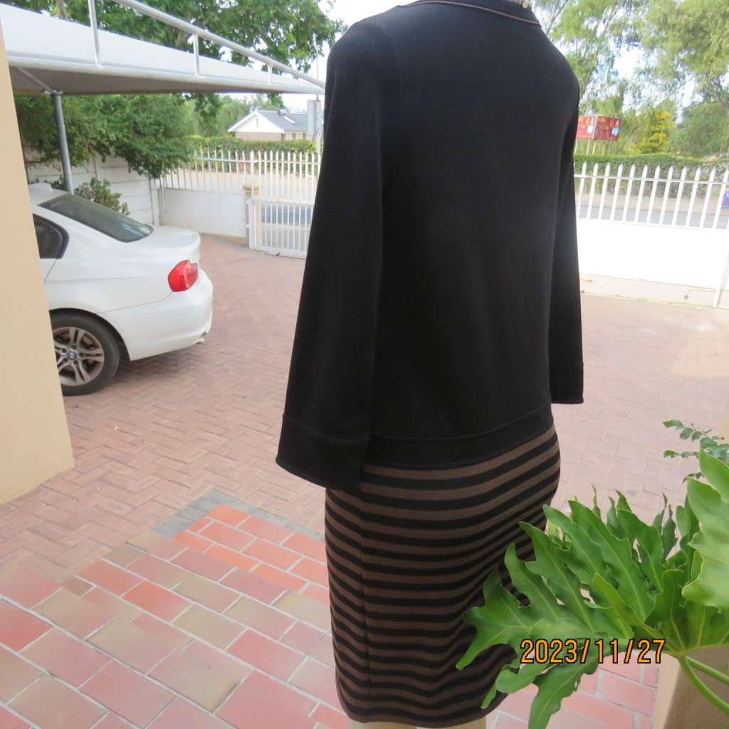 Elegant black jersey shift dress with black/brown striped bottom. Long sleeves. Size 34 from Korea.