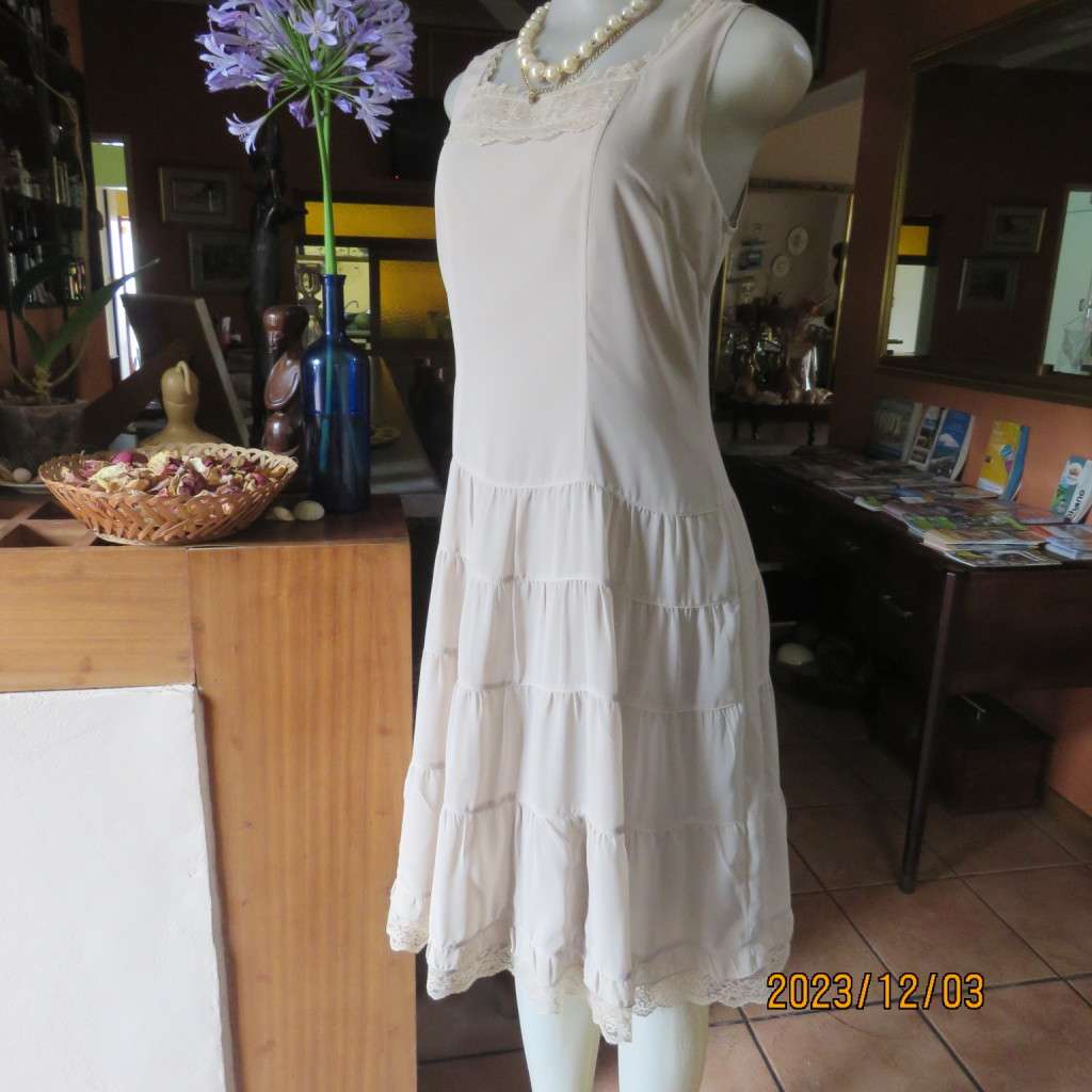Smart ecru colour dropped waist dress with tiered bottom. Size 36. Square neckline. Fully lined.