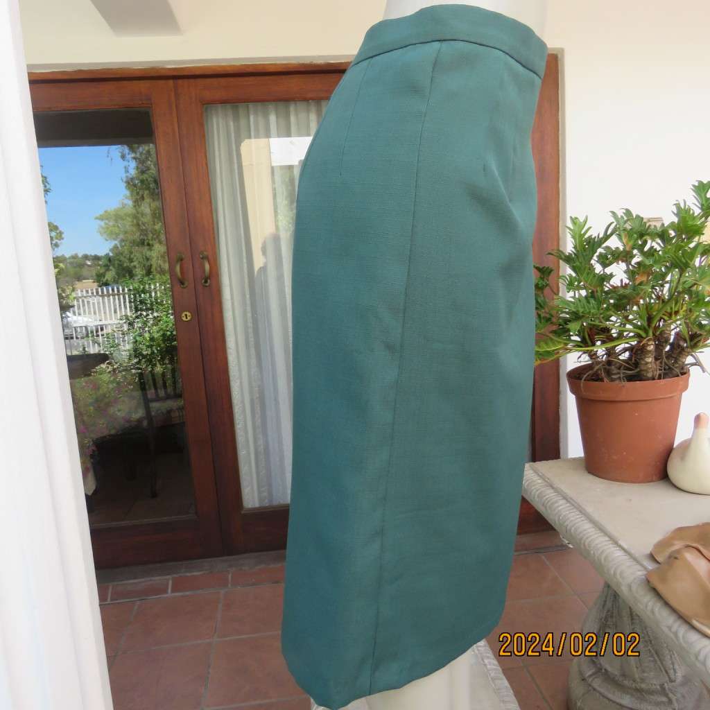 Smart dark green bottle green fully lined pencil size 36 skirt. With pleat and zip at back. As new.