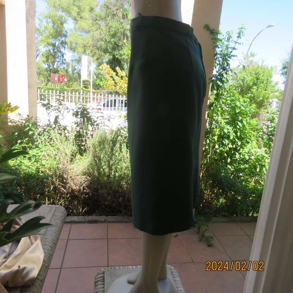 Smart dark green bottle green fully lined pencil size 36 skirt. With pleat and zip at back. As new.