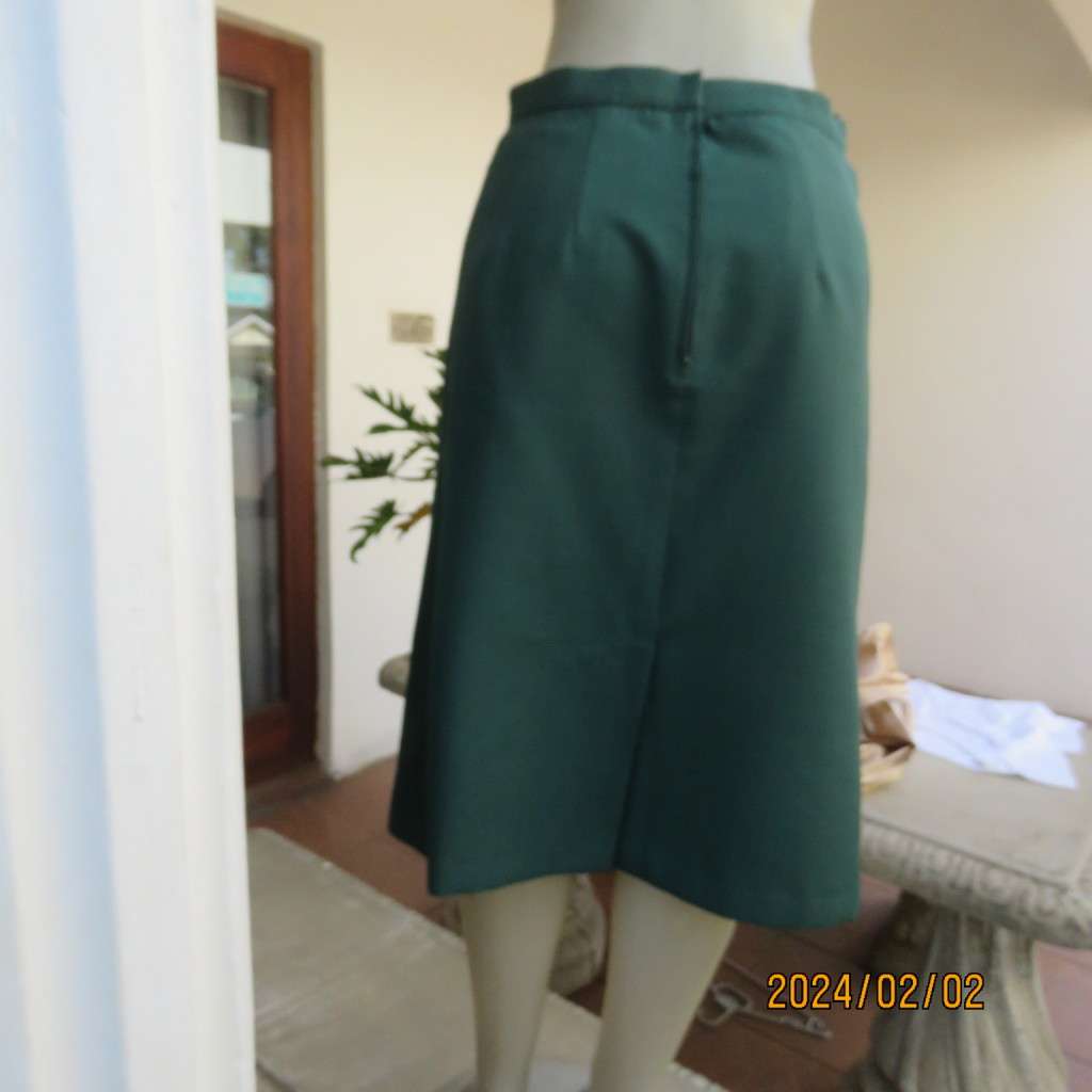 Smart dark green bottle green fully lined pencil size 36 skirt. With pleat and zip at back. As new.