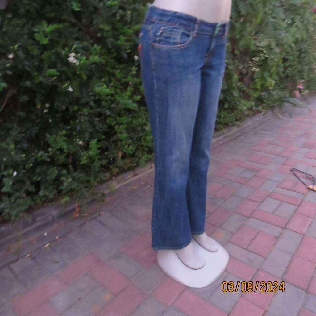 Pair of blue denim cotton Slouch fit low rise jeans by ST BERNARD size 34.Bootlegged. Very good cond