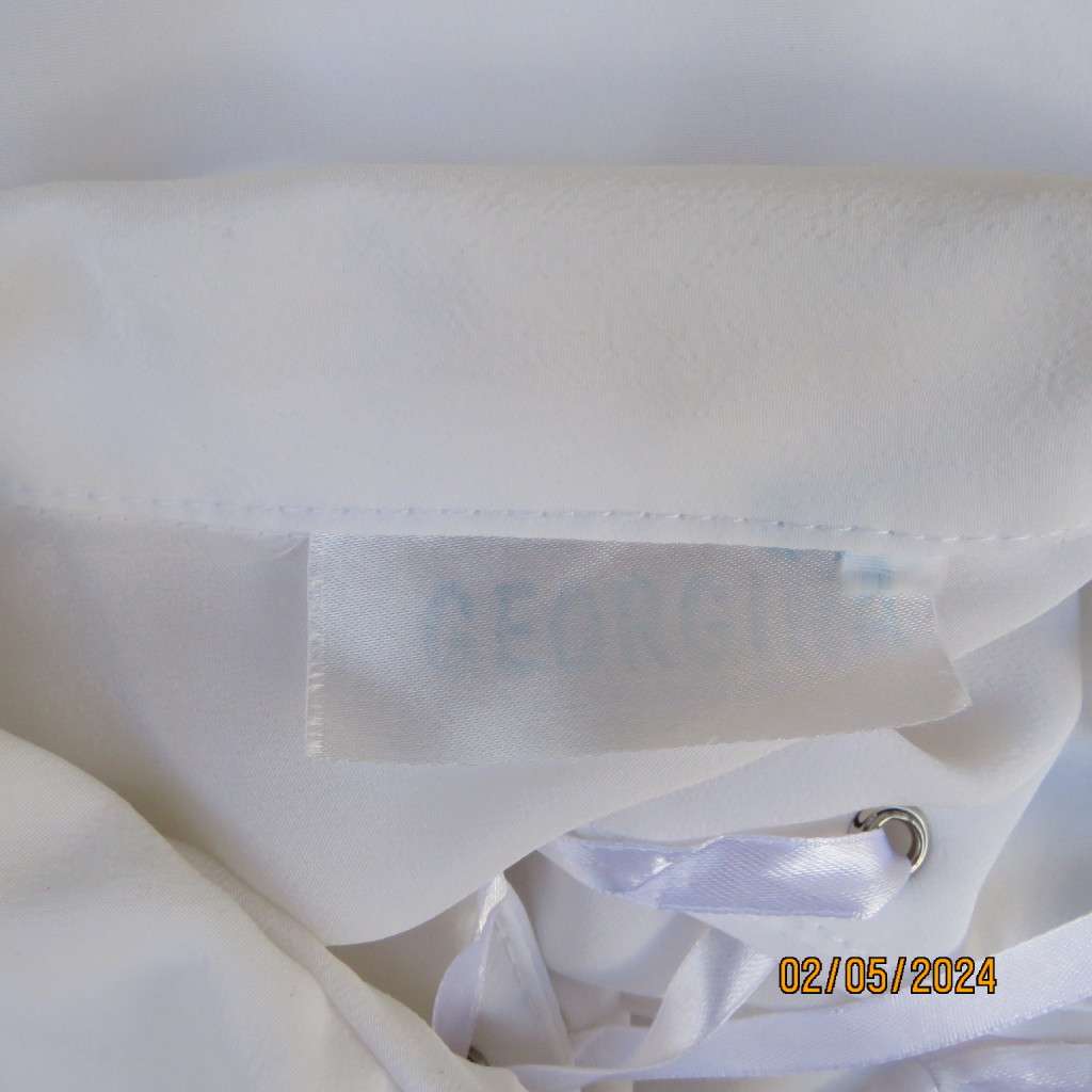 Pretty white polyester slip over top with long sleeves/flare cuffs. Front braided opening.Size 38/40