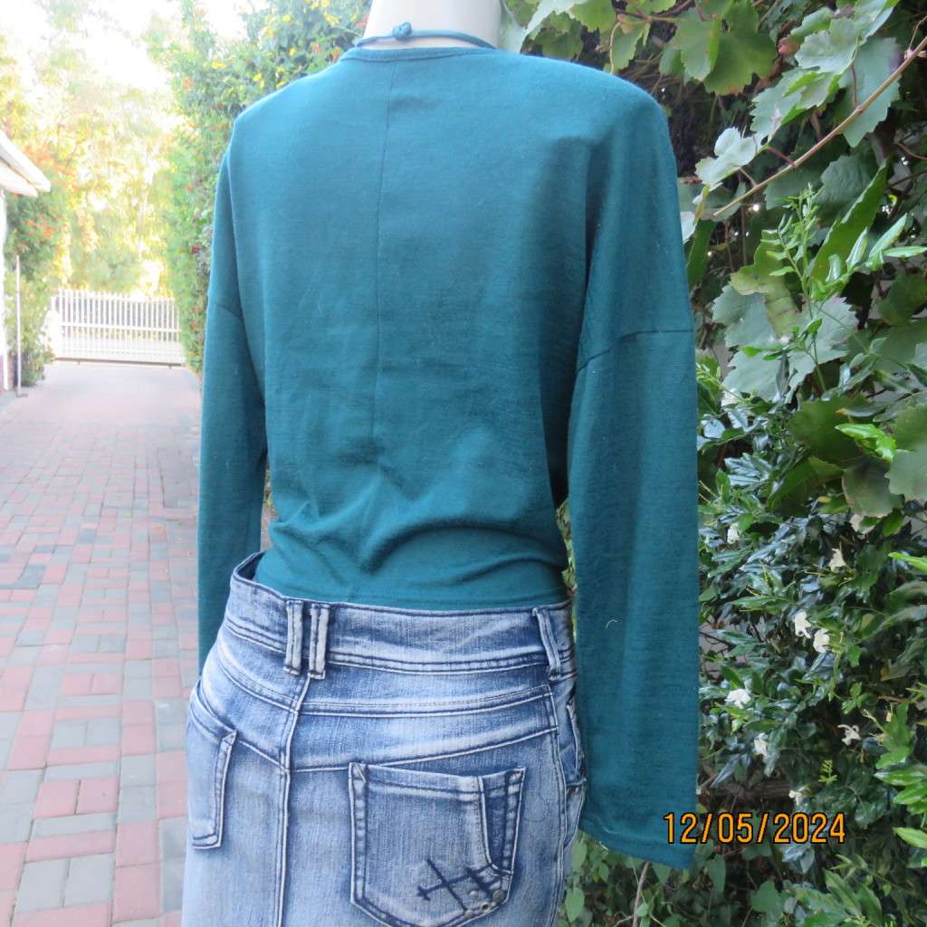 Pretty soft warm acrylic knit long sleeve  top with stretch. Straps to tie on front. Size 38. As new