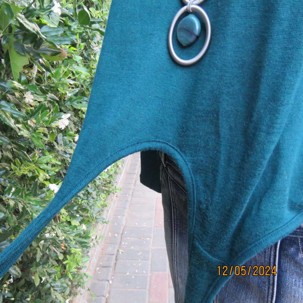 Pretty soft warm acrylic knit long sleeve  top with stretch. Straps to tie on front. Size 38. As new