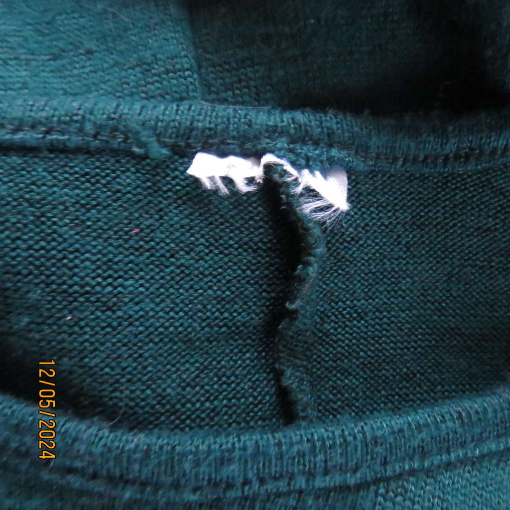 Pretty soft warm acrylic knit long sleeve  top with stretch. Straps to tie on front. Size 38. As new