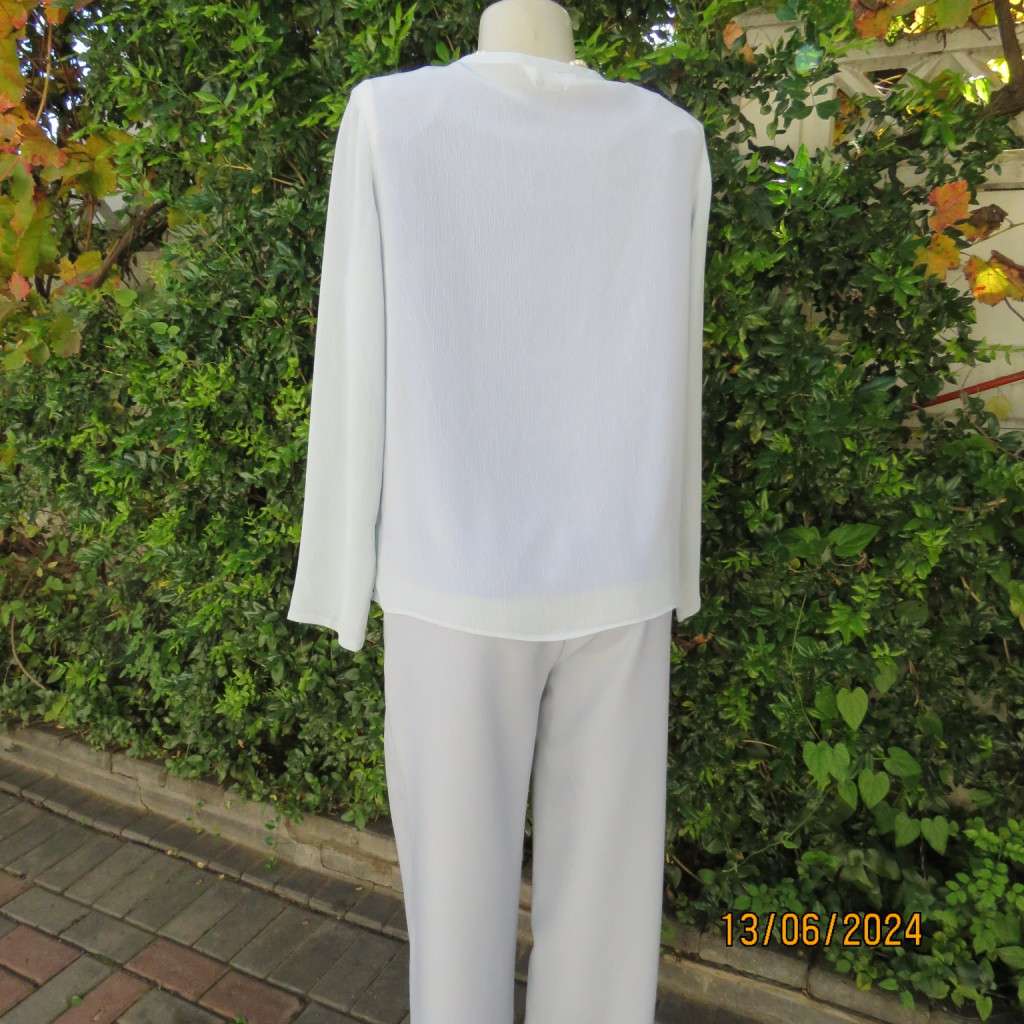 Dainty powder blue long sleeve cover-up in crinkled polyester. 3 tiny button closure.Size 38. As new
