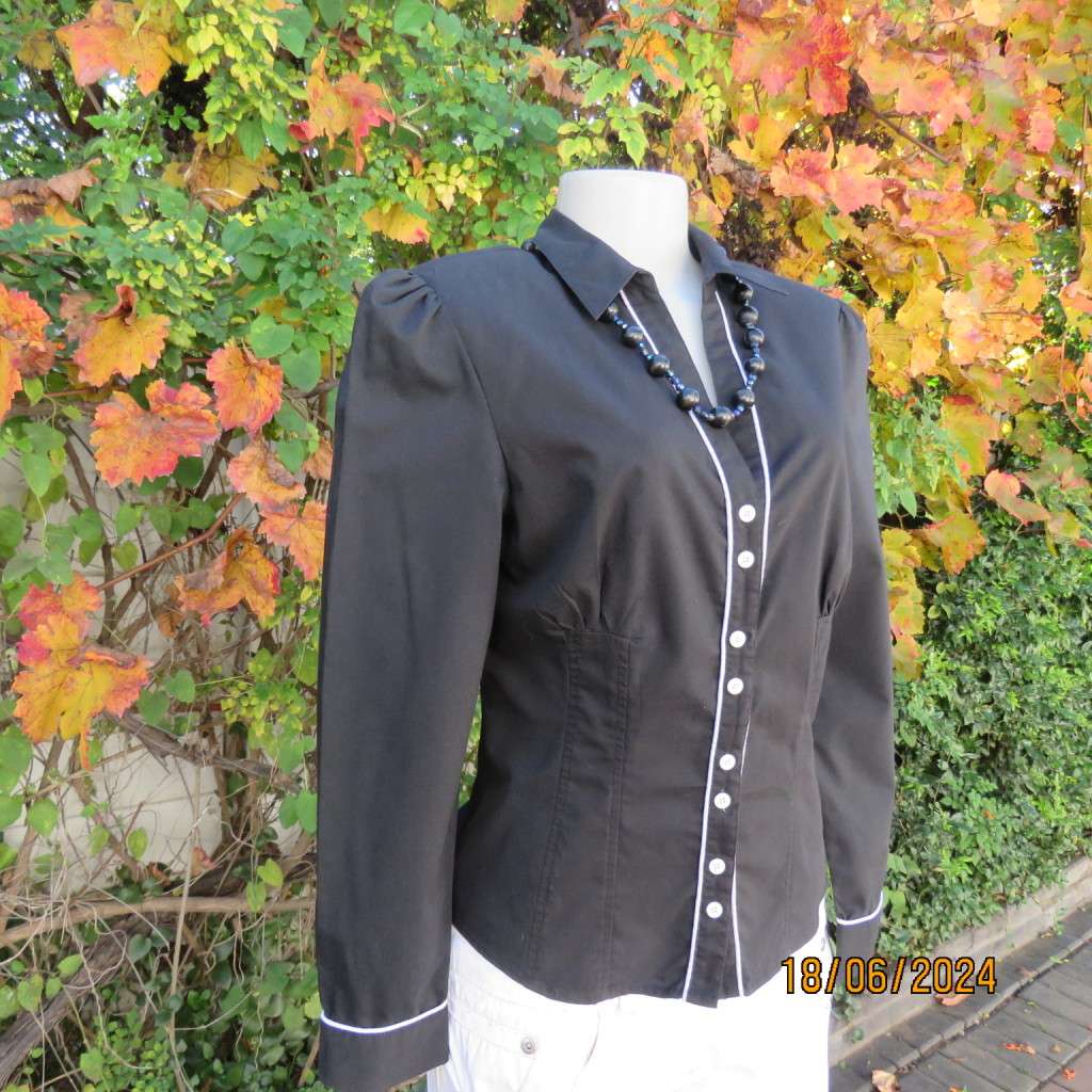 Charming long sleeves black tailored top. V button down front/collar. White edging/buttons.Size 36.