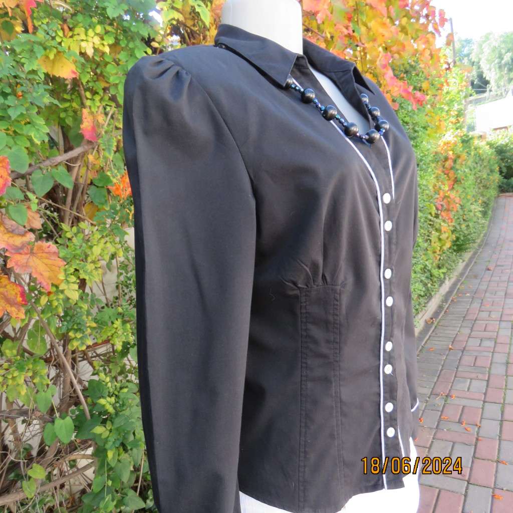 Charming long sleeves black tailored top. V button down front/collar. White edging/buttons.Size 36.