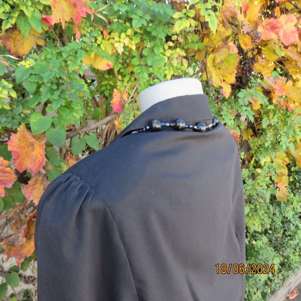 Charming long sleeves black tailored top. V button down front/collar. White edging/buttons.Size 36.