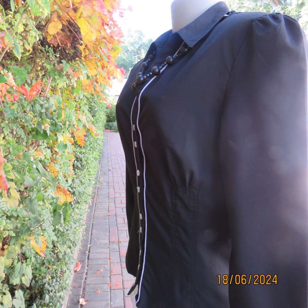 Charming long sleeves black tailored top. V button down front/collar. White edging/buttons.Size 36.