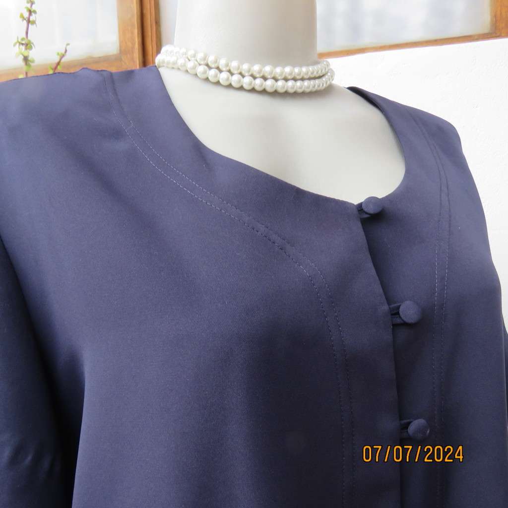 Smart, as new collarless navy silky polyester short sleeve top. Size 40.Close with loops and buttons