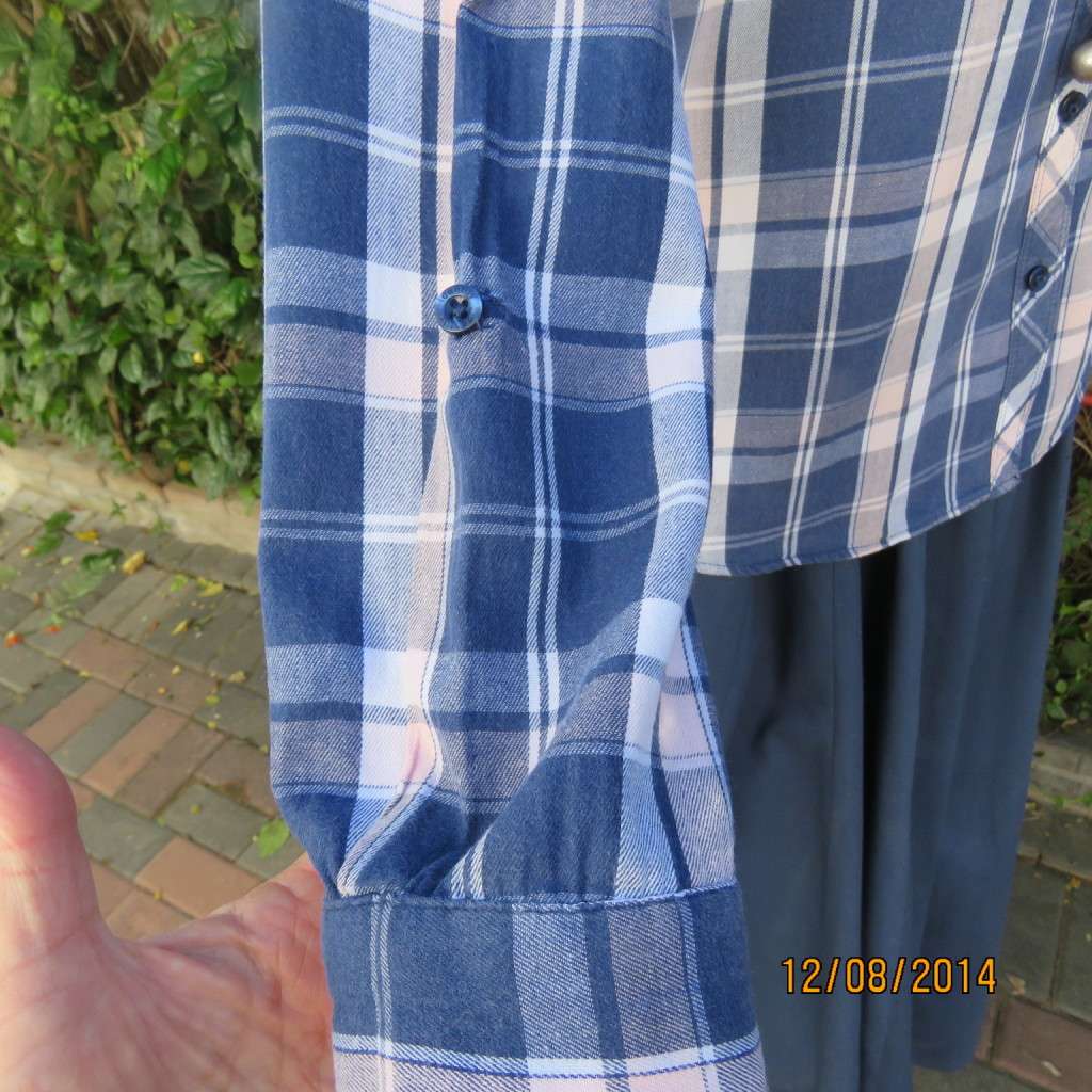 Casual long sleeve check button down top in blues.Peach touches. Two pockets.By IDENTITY.Size 36.
