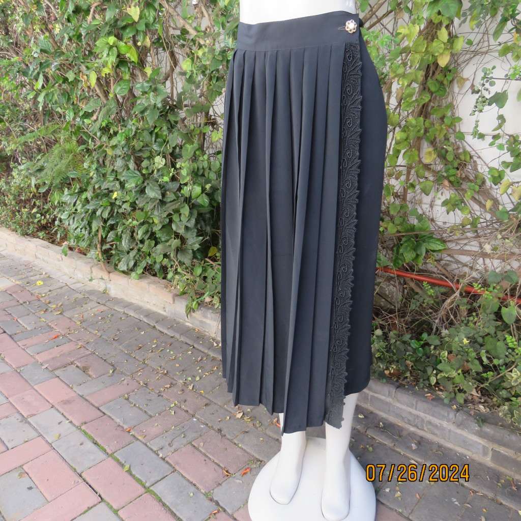Very black silky,shiny knife pleated fold over ankle lenght skirt. Size 34/36 by TRUWORTHS. New cond