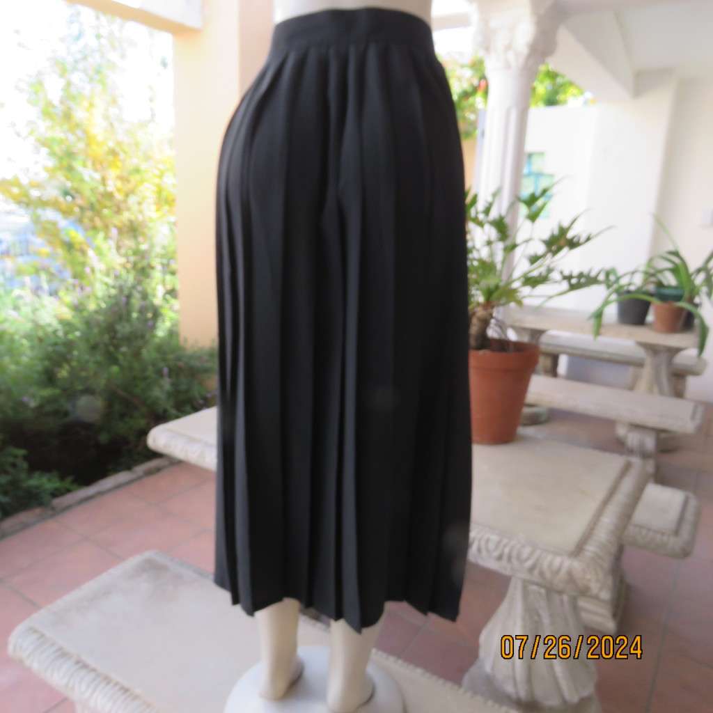Very black silky,shiny knife pleated fold over ankle lenght skirt. Size 34/36 by TRUWORTHS. New cond
