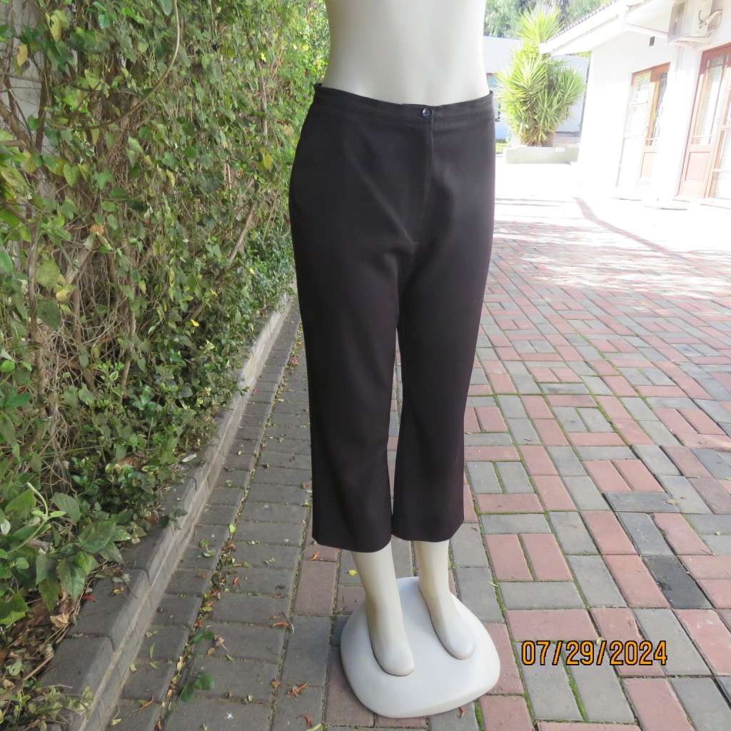 Black silky,shiny stretch polyester ankle length pants by MERIEN HALL size 35. Very good condition
