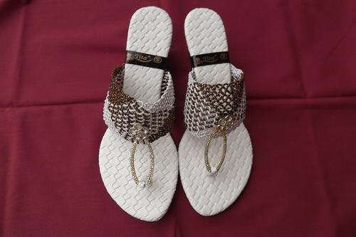 Pair of Tita Sandals in Brown and White.